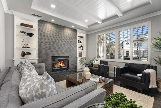 living room with visible vents, beam ceiling, wood finished floors, recessed lighting, and a large fireplace