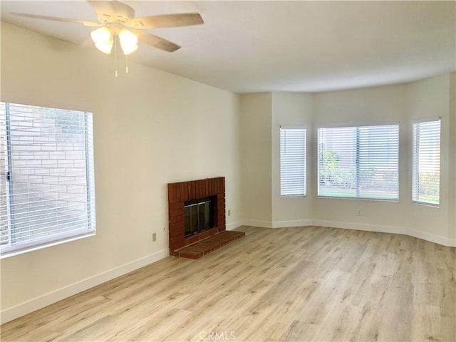 unfurnished living room with light hardwood / wood-style flooring, a fireplace, and ceiling fan