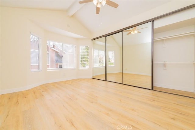 unfurnished bedroom featuring hardwood / wood-style flooring, lofted ceiling with beams, and ceiling fan