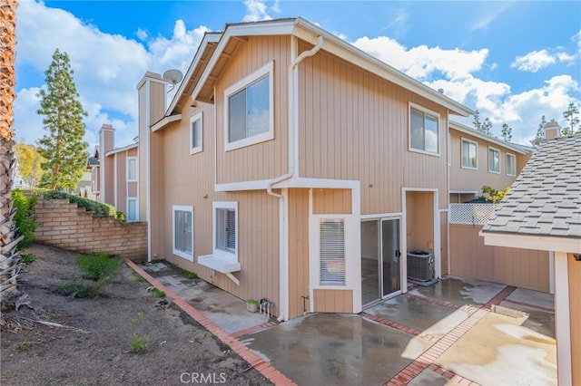 back of house featuring central AC unit and a patio area