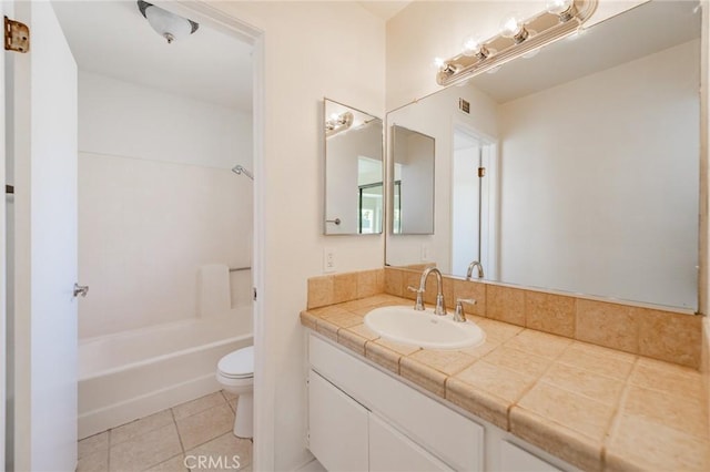 bathroom with tile patterned flooring, vanity, and toilet