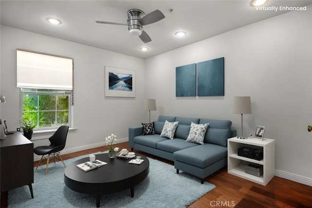 living room with wood-type flooring and ceiling fan