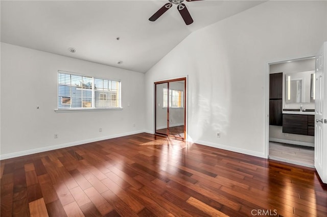 spare room featuring high vaulted ceiling, dark hardwood / wood-style floors, and ceiling fan