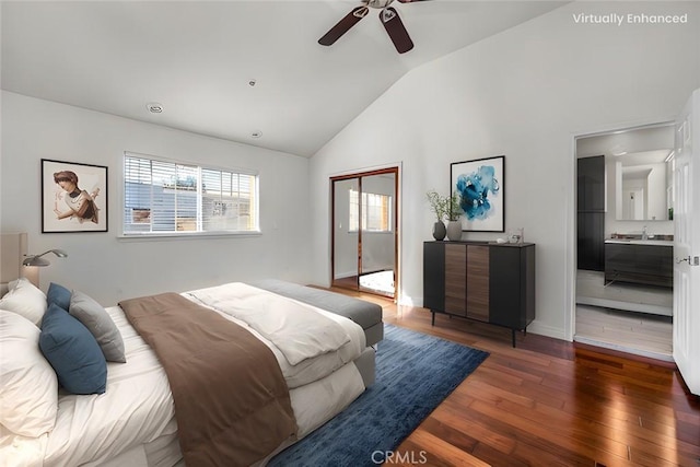 bedroom with dark hardwood / wood-style floors, lofted ceiling, ceiling fan, ensuite bath, and a closet