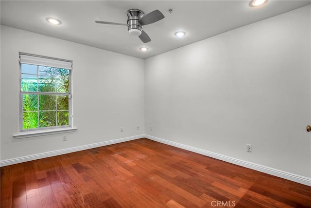 spare room with ceiling fan and wood-type flooring