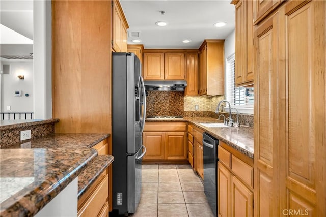 kitchen with dark stone countertops, sink, and appliances with stainless steel finishes