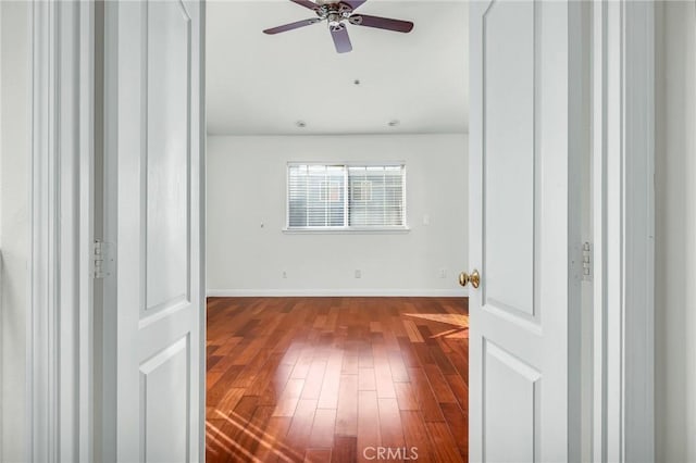 empty room featuring hardwood / wood-style floors and ceiling fan