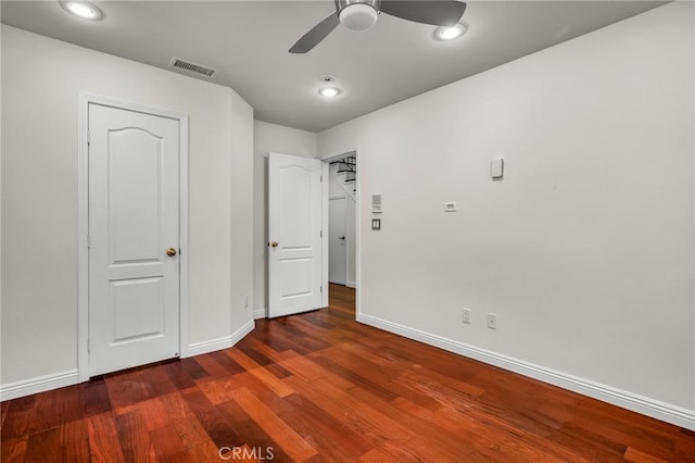 unfurnished bedroom featuring dark wood-type flooring and ceiling fan