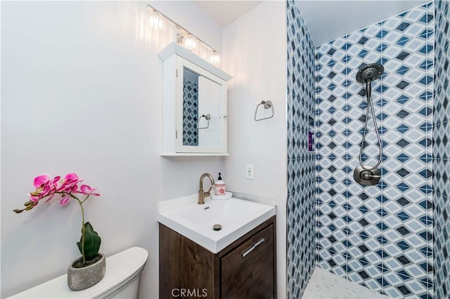 bathroom featuring vanity, a shower, and toilet