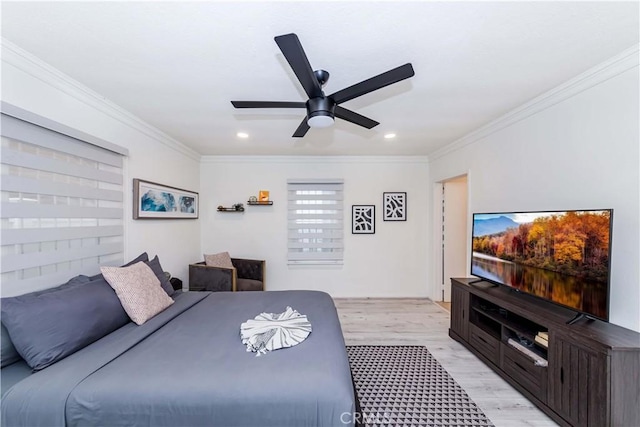 bedroom with crown molding, ceiling fan, and light hardwood / wood-style floors