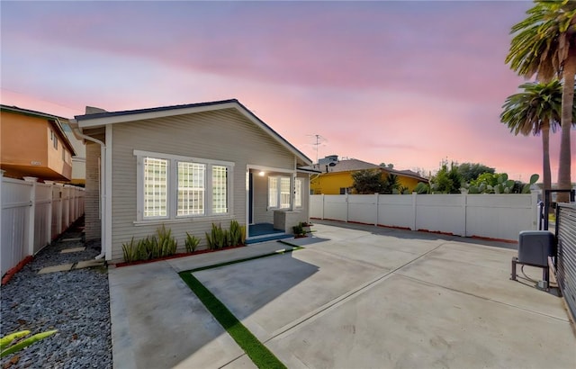 back house at dusk with a patio