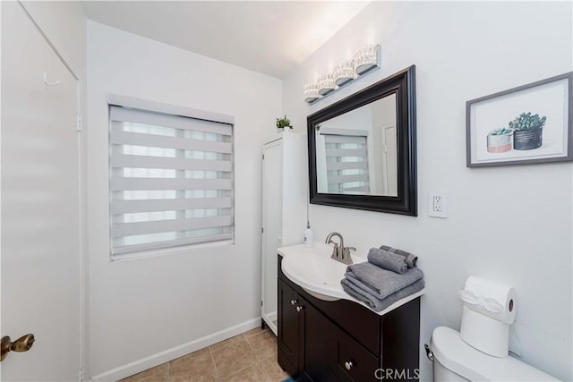 bathroom featuring vanity, tile patterned flooring, and toilet