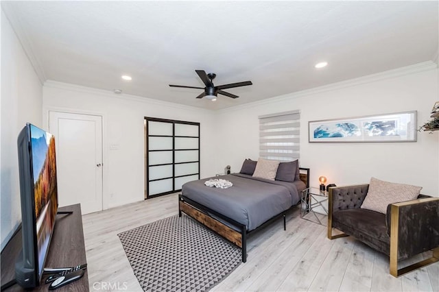 bedroom featuring crown molding, ceiling fan, and light hardwood / wood-style floors