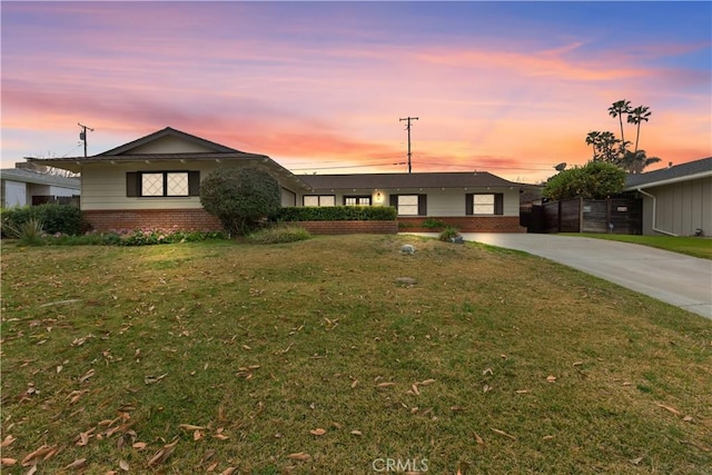 ranch-style house featuring a lawn