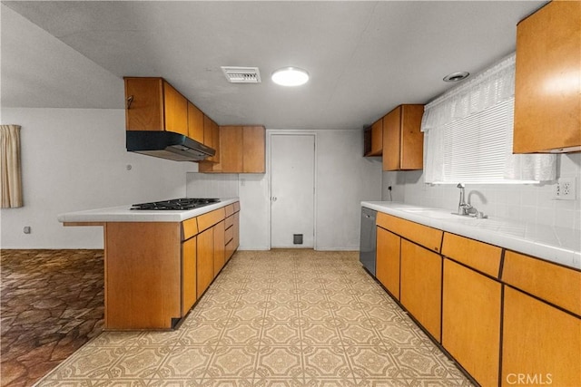 kitchen featuring stainless steel dishwasher, black gas stovetop, sink, and decorative backsplash