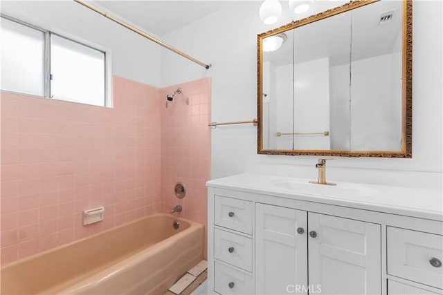 bathroom with vanity and tiled shower / bath combo