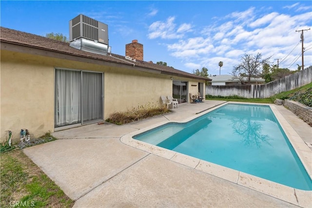 view of pool with a patio and central air condition unit