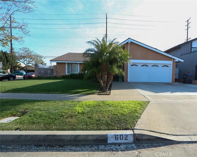 ranch-style home featuring a garage and a front lawn