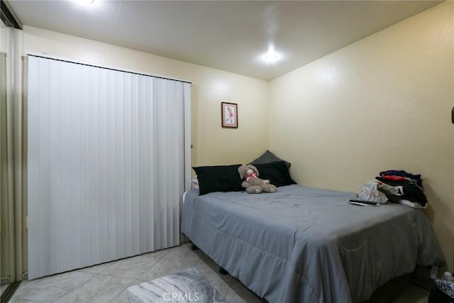 bedroom featuring light tile patterned flooring