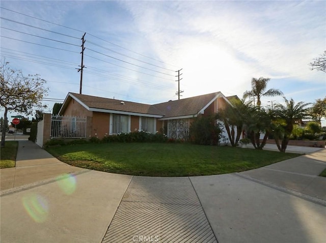 ranch-style house with a front lawn