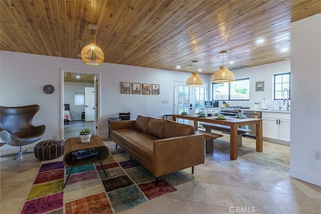 living room featuring sink, a wealth of natural light, and wooden ceiling