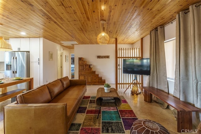 living area featuring wooden ceiling, tile patterned flooring, and stairs
