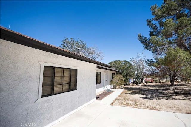 view of property exterior with a patio and stucco siding