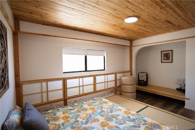 bedroom with wood ceiling and wood finished floors