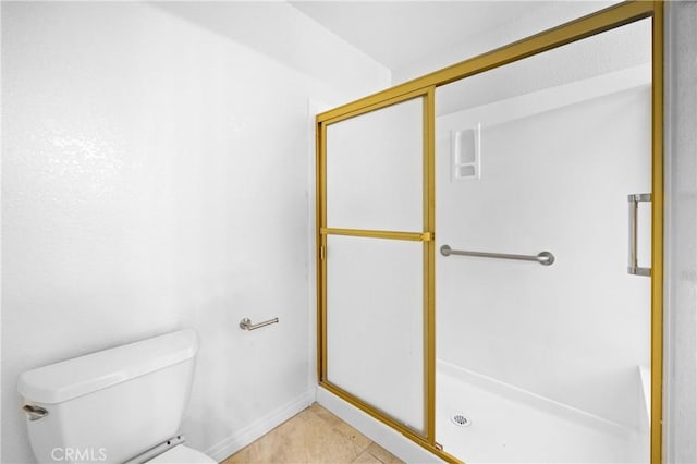 full bathroom with tile patterned flooring, a shower stall, and toilet