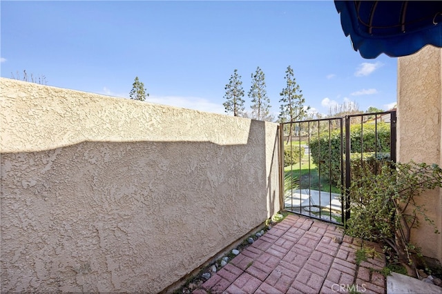 view of patio with a gate