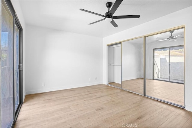 unfurnished bedroom with light wood finished floors, a closet, a ceiling fan, access to outside, and baseboards