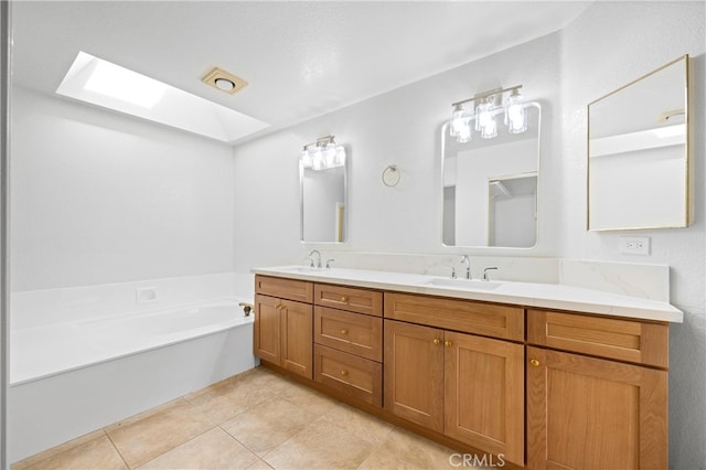 full bathroom featuring double vanity, a skylight, a sink, and tile patterned flooring