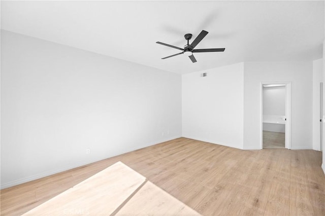 unfurnished room featuring light wood-style floors, ceiling fan, visible vents, and baseboards