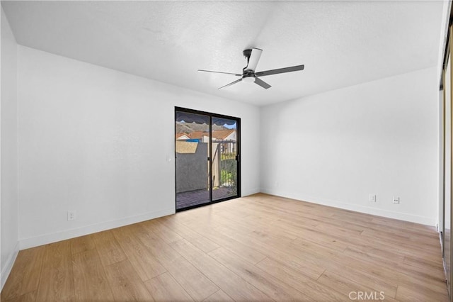 unfurnished room featuring baseboards, a textured ceiling, light wood-style flooring, and a ceiling fan