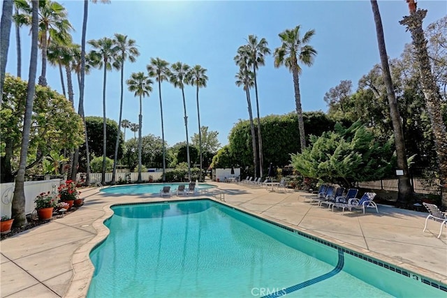 pool featuring fence and a patio