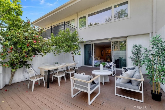 deck featuring an outdoor hangout area and outdoor dining space