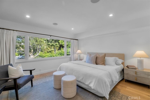bedroom with light wood-style flooring, baseboards, and recessed lighting