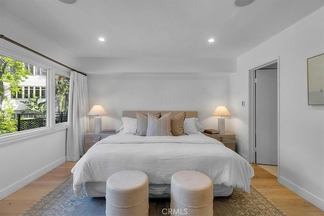 bedroom with light wood-style flooring, baseboards, and recessed lighting