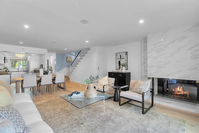 living room with stairs, wood finished floors, and recessed lighting