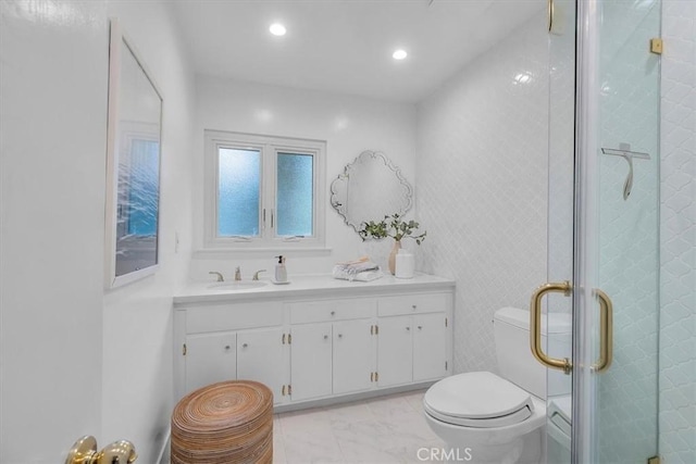 bathroom with toilet, a stall shower, recessed lighting, marble finish floor, and vanity