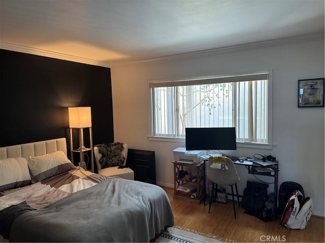 bedroom featuring crown molding and hardwood / wood-style flooring