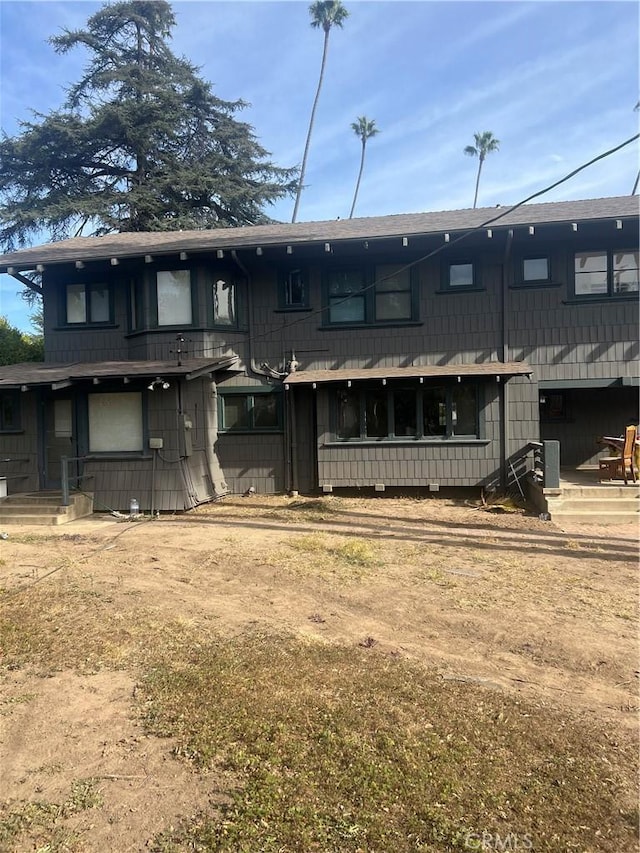 back of house with central air condition unit