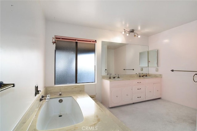 bathroom featuring vanity and a bath