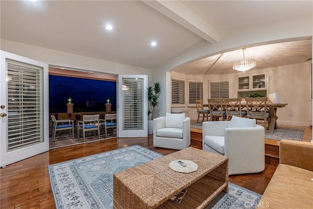 living area featuring vaulted ceiling with beams, dark wood-style floors, baseboards, and a chandelier