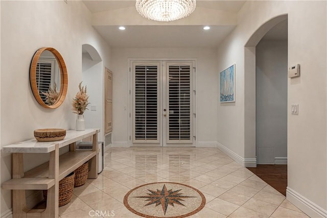 hall featuring recessed lighting, french doors, baseboards, and an inviting chandelier