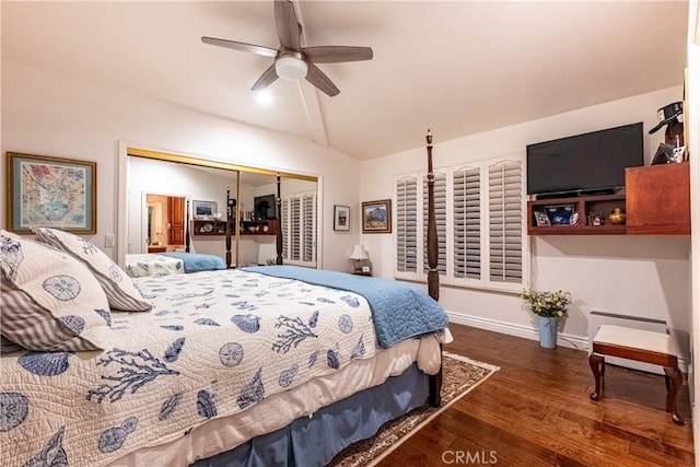 bedroom with dark wood finished floors, lofted ceiling, a closet, ceiling fan, and baseboards