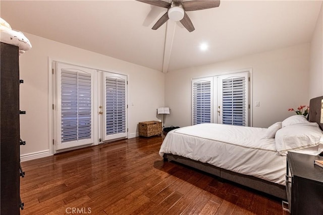 bedroom featuring lofted ceiling, dark wood-type flooring, baseboards, and access to exterior