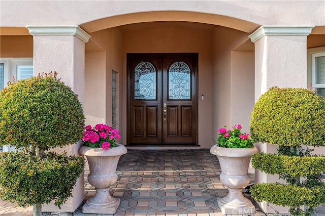 doorway to property with stucco siding