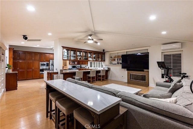 living room with lofted ceiling with beams, light wood-style flooring, recessed lighting, a ceiling fan, and a wall mounted AC