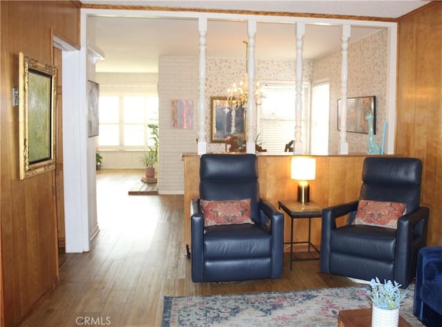 living area featuring hardwood / wood-style flooring and a chandelier